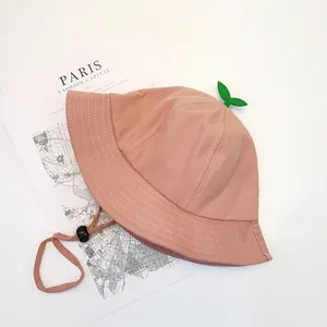 Detail of pink cotton sun hat with cute green sprout leaves and adjustable drawstring