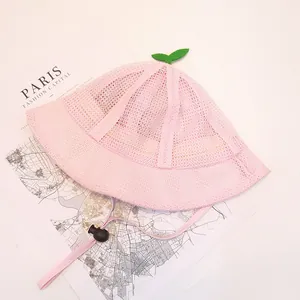 Detailed macro of pink mesh baby sun hat with cute green sprout and adjustable strap