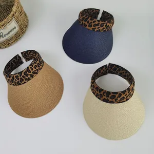 Detail of three straw visors in blue, camel and cream with leopard print headbands