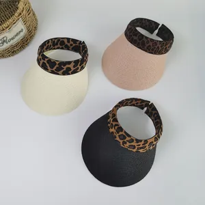 Detailed top view of wide brim straw sun visors with leopard print headbands in three colors