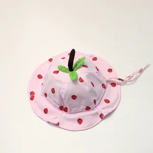 Detail of pink strawberry print baby sun hat with 3D leaf top and secure chin straps