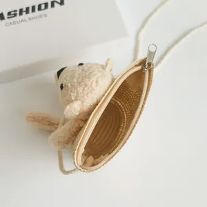 Detail view of woven panda mini crossbody bag with soft plush bear and silver zipper