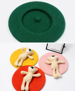 Detail of wool beret featuring a cute 3D plush teddy bear ornament and multiple color options
