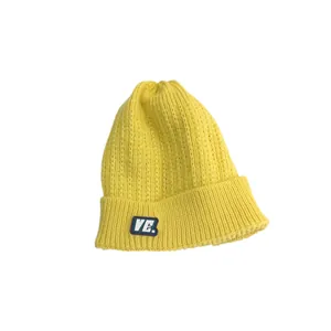 Lemon yellow cable knit beanie with VE. logo patch and ribbed cuff in a minimalist view