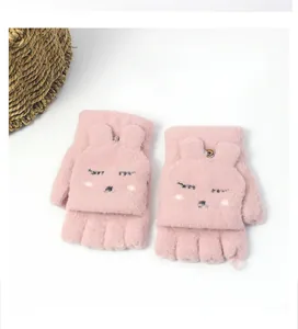 Detail of pink knitted flip top gloves featuring a cute cartoon rabbit design and button