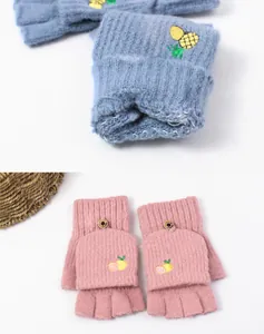 Detail of knitted convertible gloves with thick lining and cute fruit embroidery motifs