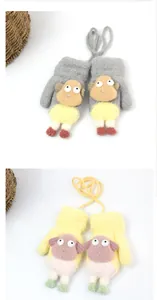 Detail of warm plush knitted children's mittens with cute sheep design and neck lanyard