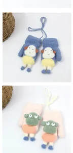 Detail of plush lamb-patterned mittens with neck strings for toddlers in navy and pink