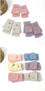 Detail of knitted convertible gloves with fruit embroidery and wooden buttons
