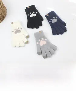 Detailed view of cat paw pattern and thick knit texture on warm touchscreen gloves