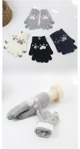 Detail of knitted touchscreen gloves with cat paw patterns in four various colors