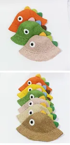 Detalle de sombreros de sol de dinosaurio en varios colores con tejido hueco transpirable