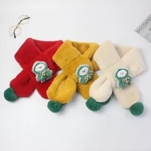 Close-up of plush winter scarves in red, yellow and beige with cute cartoon charms