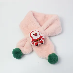 Detailed close-up of pink plush scarf with green pom poms and Santa Claus patch