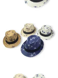 Detail view of woven straw sun hats featuring palm tree prints in four summer colors