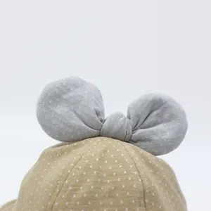 Polka dot cotton baby sun hat in khaki with a large grey bow decoration