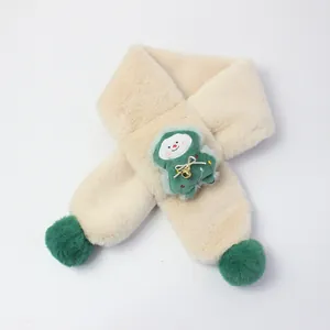 Close-up of plush children's scarf with green pom-poms and cartoon mascot decoration