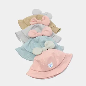 Baby cotton sun hat with bow decoration and polka dot pattern in multiple soft colors
