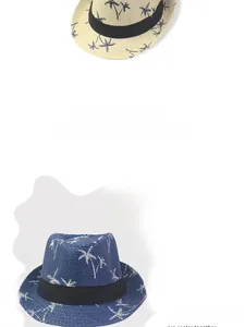 Detail of straw Panama hats in beige and blue featuring white palm tree patterns