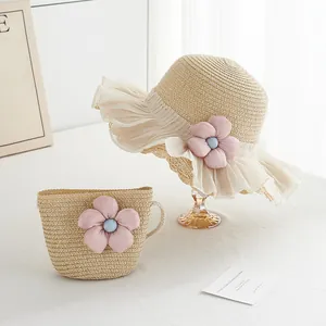 Detail of children's straw hat and matching bag set with pink floral and tulle trim