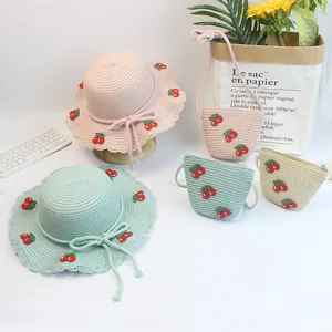 Matching set of straw sun hats and bags with cherry embroidery in multiple colors