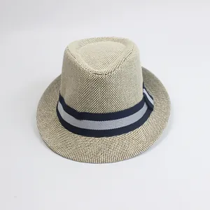 Close-up of fine beige paper straw weave and striped decorative band on a fedora hat