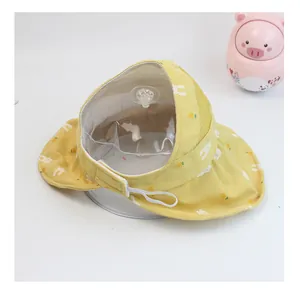 Detail of children's yellow sun hat with rabbit pattern and detachable face shield