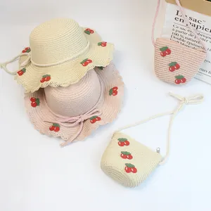 Detailed view of straw hats and matching crossbody bags with cute cherry embroidery
