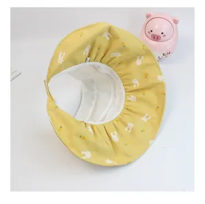 Detail view of yellow sun hat with rabbit prints and breathable white mesh top for kids