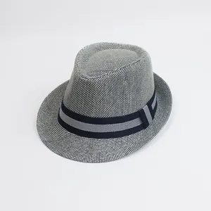 Close-up of classic navy blue and white paper woven fedora texture with striped band