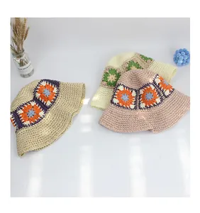 Close-up of handmade crochet sunflower straw bucket hats with bohemian patterns