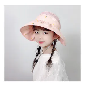 Close-up of pink sun hat with rabbit patterns and adjustable chin strap on girl