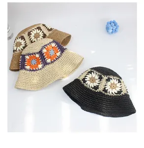 Detailed top view of three handmade crochet straw hats with hollow floral patterns