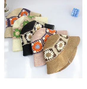 Flat lay of handmade sunflower crochet hats in five colors for beach vacation