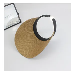 Close-up of straw woven top visor with black fabric ribbon edge and detailed texture