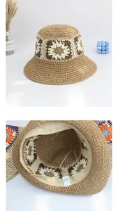 Detail view of woven straw hat showing internal 100% paper tag and adjustable sweatband