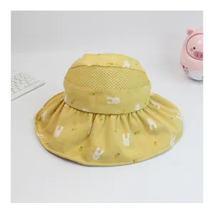 Detail of kids yellow sun hat with mesh top and cute rabbit carrot pattern print