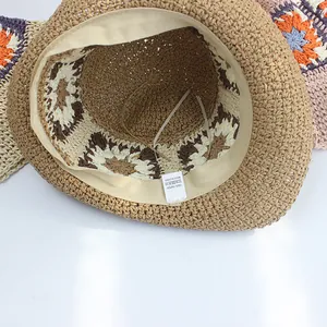 Handwoven straw hat with colorful crochet sunflowers for seaside beach vacation