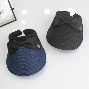 Women's open top straw sun hat with ribbon bow and gold M metal logo decoration
