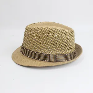 Detailed macro view of the hollow breathable mesh weave on a brown straw fedora hat