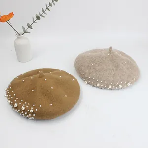 Detailed view of wool berets with white pearls and sparkling rhinestones for women