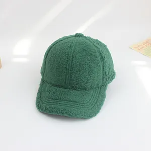 Detailed view of the green teddy fleece texture and stitching on a kids baseball cap