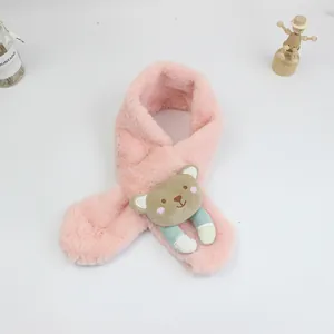 Detail of pink plush kids scarf with cute cartoon bear decoration and cross-over design