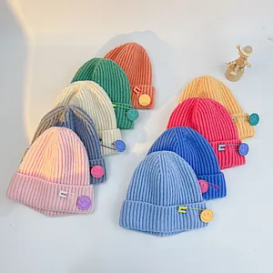 Thick ribbed knit beanies for kids with colorful safety pin smiley charms in various colors