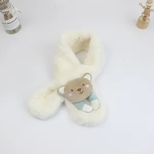 Detailed close-up of white plush kids' scarf with brown cartoon bear and striped fabric paws