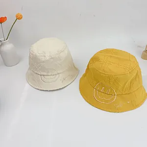 Detail of cotton smile fisherman hats with frayed edges and star embroidery