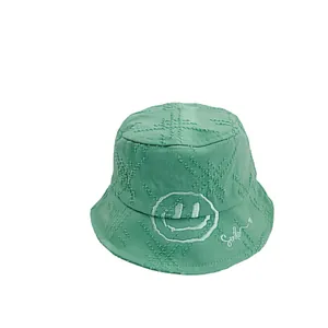 Kids' green quilted cotton bucket hat with smile embroidery and soft brushed texture
