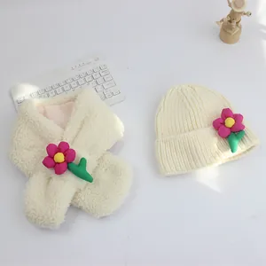 Detail von Plüschschal und Strickmütze in Creme mit rosa Stoffblumen für Kinder