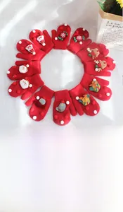 Flat lay of red Christmas knitted gloves with reindeer and snowflake embroidery details