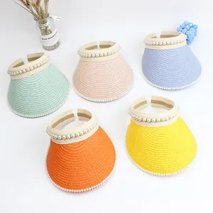 Detail of straw sun visors with pearl embellishments in multiple vibrant summer colors